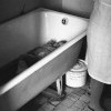 «Один в ванной», пока надевают сухие штаны на одного ребенка, другой дожидается своей очереди в ванной, Дом ребенка № 2. Новокуз «Один в ванной», пока надевают сухие штаны на одного ребенка, другой дожидается своей очереди в ванной, Дом ребенка № 2. Новокуз