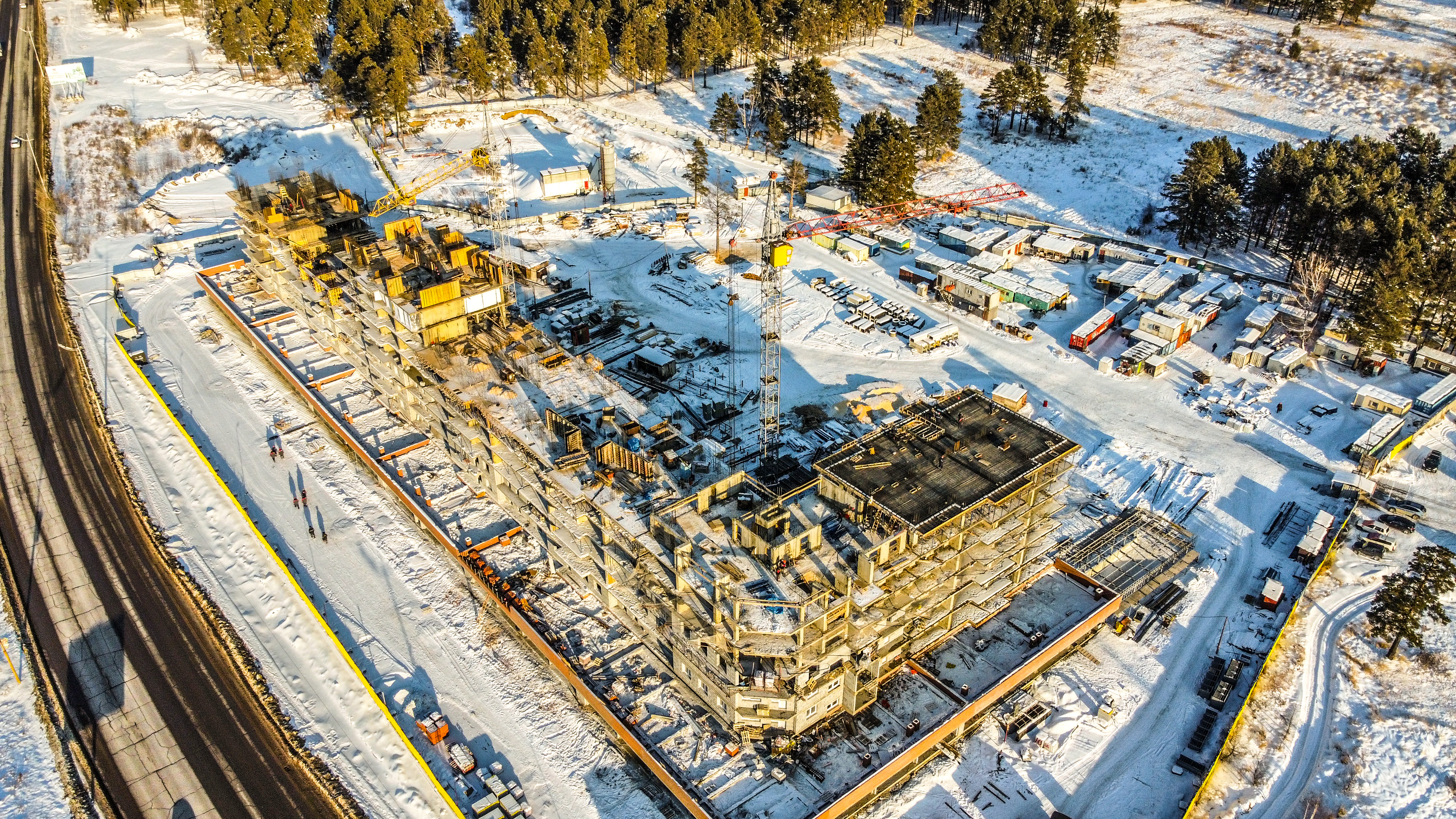 За окном идет стройка, работает кран…